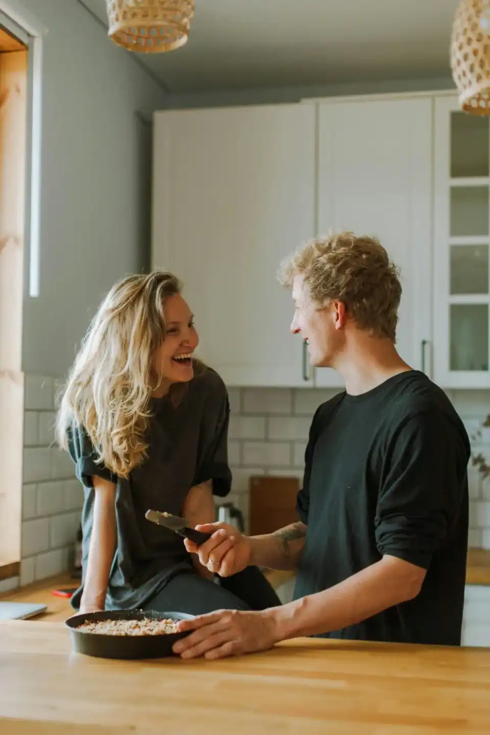 Happy Sarasota homeowners stand in a freshly painted kitchen