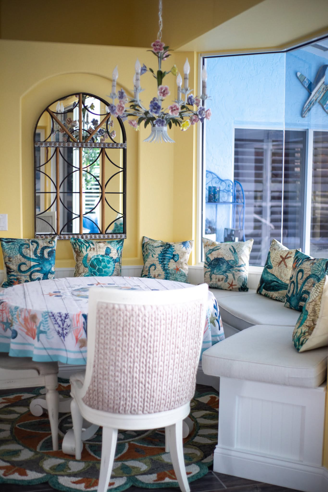Coastal dining area with built-in seating and professional interior painting